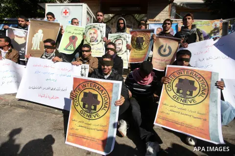 Palestinians who covered their eyes with black ribbons demonstrate in support of Palestinian prisoners held in Israeli jails, some of whom are observing a hunger strike, in Gaza City on December 22, 2012. Photo by Majdi...