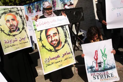 Palestinians who covered their eyes with black ribbons demonstrate in support of Palestinian prisoners held in Israeli jails, some of whom are observing a hunger strike, in Gaza City on December 22, 2012. Photo by Majdi...