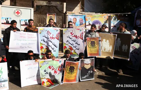 Palestinians who covered their eyes with black ribbons demonstrate in support of Palestinian prisoners held in Israeli jails, some of whom are observing a hunger strike, in Gaza City on December 22, 2012. Photo by Majdi...