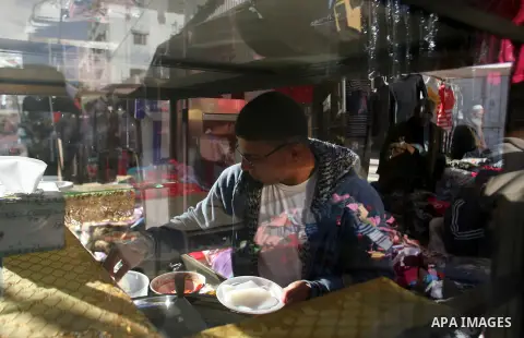 A Palestinian vendor sells sweets at the saturday's popular market in Rafah southern Gaza strip on 22 December 2012. Normal life in Gaza resumed remarkably fast after a ceasefire agreement was announced following eight d...