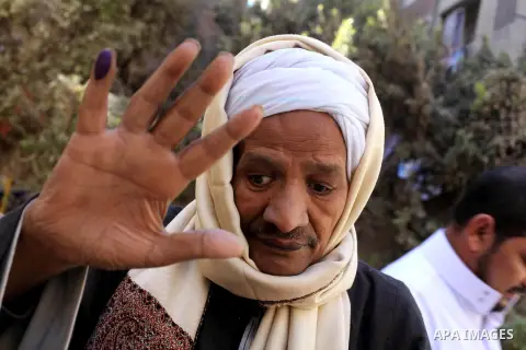An Egyptian man shows his ink-stained finger after casting his vote in the final stage of a referendum draft constitution in Cairo, on December 22, 2012. Egyptians are voting in the final round of a referendum on a new c...