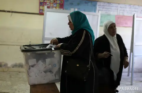 An Egyptian woman casts her ballot at a polling station during the second round of a referendum on a new draft constitution in Giza, south of Cairo, on December 22, 2012. Egyptians are voting in the final round of a refe...