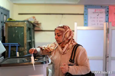 An Egyptian woman casts her ballot at a polling station during the second round of a referendum on a new draft constitution in Giza, south of Cairo, on December 22, 2012. Egyptians are voting in the final round of a refe...