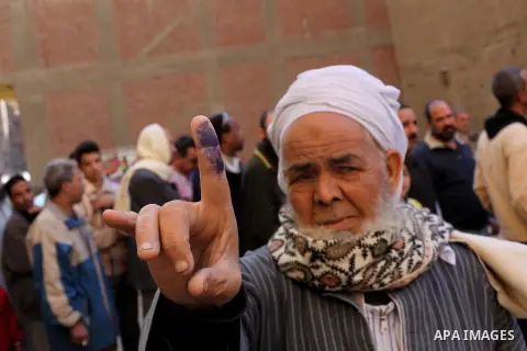 An Egyptian man shows his ink-stained finger after casting his vote in the final stage of a referendum draft constitution in Cairo, on December 22, 2012. Egyptians are voting in the final round of a referendum on a new c...