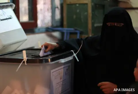 An Egyptian woman casts her ballot at a polling station during the second round of a referendum on a new draft constitution in Giza, south of Cairo, on December 22, 2012. Egyptians are voting in the final round of a refe...