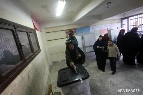 An Egyptian woman casts her ballot at a polling station during the second round of a referendum on a new draft constitution in Giza, south of Cairo, on December 22, 2012. Egyptians are voting in the final round of a refe...