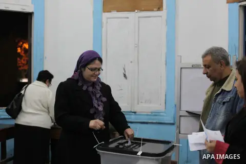 An Egyptian woman casts her ballot at a polling station during the second round of a referendum on a new draft constitution in Giza, south of Cairo, on December 22, 2012. Egyptians are voting in the final round of a refe...