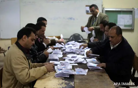 Officials count ballots after polls closed in Giza, south of Cairo, on December 22, 2012. Egyptians are voting in the final round of a referendum on a new constitution championed by President Mohamed Morsi and his Islami...