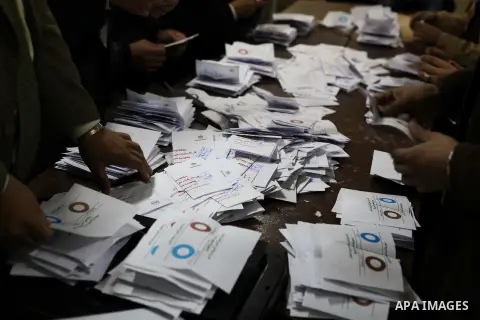 Officials count ballots after polls closed in Giza, south of Cairo, on December 22, 2012. Egyptians are voting in the final round of a referendum on a new constitution championed by President Mohamed Morsi and his Islami...