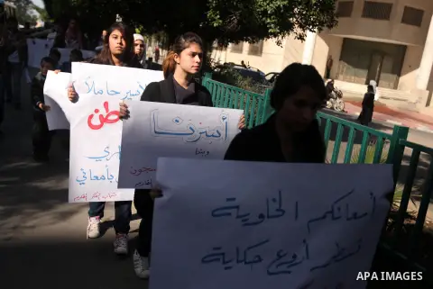 Palestinians youth hold a poster to show his support for Palestinian prisoners currently being held in Israeli jails, some of whom are on hunger strike, in Gaza city, 23, 2012. Photo by Majdi Fathi