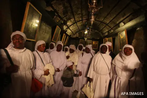 Pilgrims are seen near the 'Grotto,' where Christians believe the Virgin Mary gave birth to Jesus Christ, in the Church of the Nativity, in the West Bank town of Bethlehem on Christmas Day, 24 December 2012. Photo by Iss...