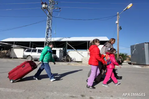 Palestinian Christians walk towards Erez crossing in the northern Gaza Strip on Dec. 24, 2012 after Israel granted 557 permits for Christians from the isolated and impoverished territory to travel to the West Bank town o...
