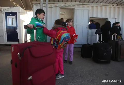 Palestinian Christians wait at the Erez crossing in the northern Gaza Strip on Dec. 24, 2012 after Israel granted 557 permits for Christians from the isolated and impoverished territory to travel to the West Bank town of...