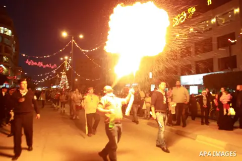 A Palestinian man spews fire from his mouth as he attends the Christmas celebrations in the West Bank city of Nablus on Dec. 24, 2012. Photo by Nedal Eshtayah
