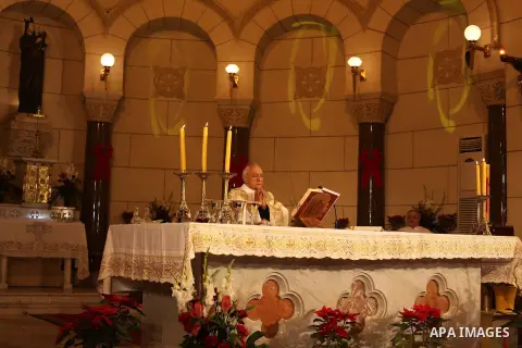 A Christian priest celebrates Christmas mass in Cairo, on December 24, 2012. Photo by Ashraf Amra