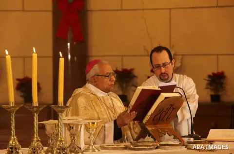 A Christian priest celebrates Christmas mass in Cairo, on December 24, 2012. Photo by Ashraf Amra