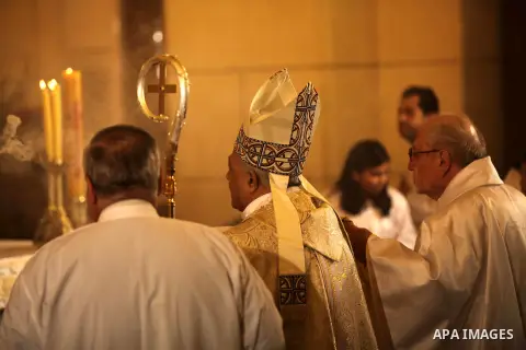 A Christian priest celebrates Christmas mass in Cairo, on December 24, 2012. Photo by Ashraf Amra