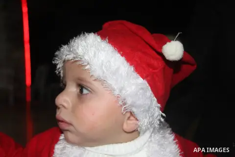 A Palestinian child dressed as Santa Claus during Christmas celebrations intside the Church of Deir Latin in Gaza city, on December 24, 2012. Photo by Ezz al-Zanoon
