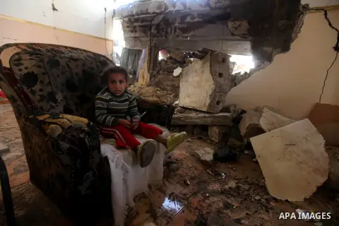 A Palestinian girl plays at her bombed house, marking the 4 th anniversary of his death during the Israel-Gaza war, in Gaza City, on Dec. 26, 2012. The three-week offensive dramatically reduced the number of rockets hitt...