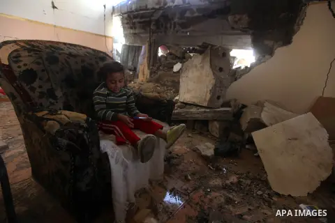 A Palestinian girl plays at her bombed house, marking the 4 th anniversary of his death during the Israel-Gaza war, in Gaza City, on Dec. 26, 2012. The three-week offensive dramatically reduced the number of rockets hitt...