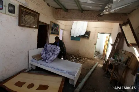 A Palestinian inspect damages in their house damaged in an Israeli air strike, marking the 4 th anniversary of the Israel-Gaza war, in Gaza City, on Dec. 26, 2012. The three-week offensive dramatically reduced the number...