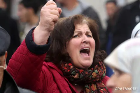 A Palestinian woman shouts during a demonstration in the West Bank city of Ramallah calling for an end in the political division and commitment to the reconciliation agreement between rival Palestinian factions Hamas and...