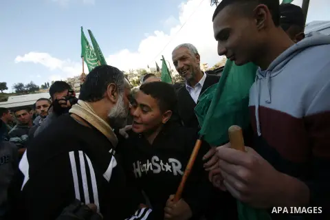 Palestinians celebrate after the Israeli authorities released prisoner Mousa Oudeh from neighborhood of Silwan in Jerusalem on December 26, 2012. Oudeh is a member of the committee for the defense of Silwan, spent two mo...