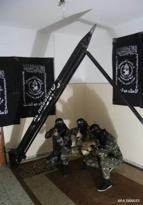 Militants of El-Naser Salah El-Deen brigades of the popular resistance, during they prefabricate a homemade rockets named (Al Naser 5) , marking the 4 th anniversary of the Israel-Gaza war, in Gaza City, on Dec. 27, 2012...