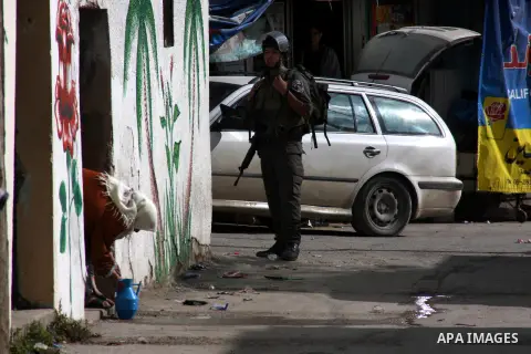 An Israeli soldier stands guard during a search carried out by Israeli soldiers after they raided the village of Urif, near Nablus, West Bank, 27 December 2012. Israeli soldiers raided the village after clashes occurred...