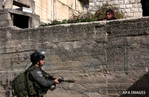 An Israeli soldier stands guard during a search carried out by Israeli soldiers after they raided the village of Urif, near Nablus, West Bank, 27 December 2012. Israeli soldiers raided the village after clashes occurred...