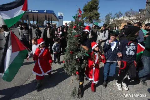 Palestinian protesters wear as Santa Claus during a protest against Jewish settlements, in the West Bank village of Nabi Saleh, near Ramallah December 28, 2012. Photo by Issam Rimawi