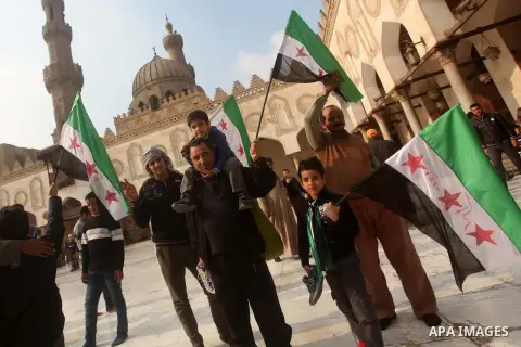 Egyptian protestors gather during a rally in support of the Syrian people and against Syria's President Bashar al-Assad at Al-Azhar mosque in Cairo, on December 28, 2012. Syrian warplanes launched air raids in Damascus p...