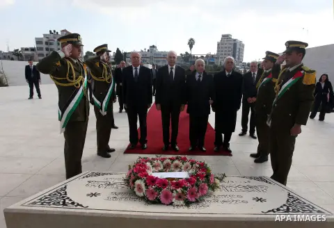 Arab League Secretary-General Nabil Elaraby, and Egyptian foreign Minister Mohamed Kamel Amr, lay a wreath at the tomb of late leader Yasser Arafat during during an arrival ceremony in the West Bank city of Ramallah, Dec...