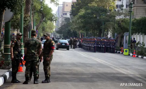 Egyptian riot police stand guard outside the Shura Council, the upper house of parliament where the Constituent Assembly drafted the country's new constitution, as protesters against Egypt's President Mohamed Morsi chant...