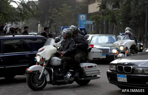 Egyptian riot police stand guard outside the Shura Council, the upper house of parliament where the Constituent Assembly drafted the country's new constitution, as protesters against Egypt's President Mohamed Morsi chant...