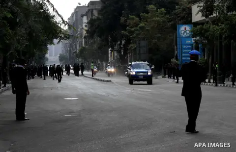 Egyptian riot police stand guard outside the Shura Council, the upper house of parliament where the Constituent Assembly drafted the country's new constitution, as protesters against Egypt's President Mohamed Morsi chant...