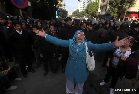 Egyptians women protest against the police officers near the Shura Council, the upper house of parliament where the Constituent Assembly drafted the country's new constitution, as protesters against Egypt's President Moh...