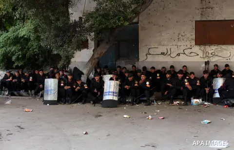 Egyptian riot police stand guard outside the Shura Council, the upper house of parliament where the Constituent Assembly drafted the country's new constitution, as protesters against Egypt's President Mohamed Morsi chant...