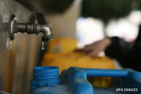 Palestinian children fill plastic bottles with drinking water in Rafah camp southern Gaza Strip, on Dec. 30, 2012. The residents of the Gaza strip suffer from lack of potable water, Israel continues to tighten its blocka...