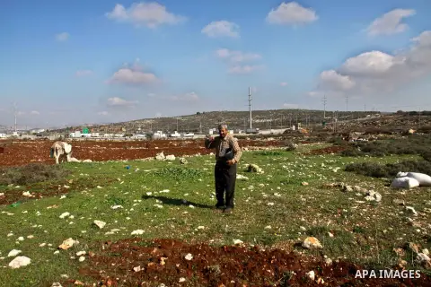 A Palestinian land owner sows wheat at his land near the Jewish settlement of Ariel near the West Bank city of Nablus on December 30, 2012. Jewish settlers attacked Palestinian farmers in the village of Yasuf and shredde...