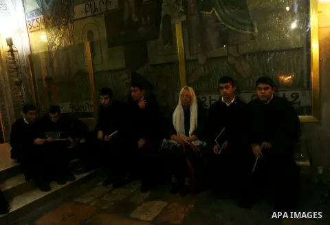 Palestinian and foreign worshippers walk outside the church of the Holy Sepulchre in Jerusalem's old city on December 30, 2012. The church has been a paramount - and for many Christians the most important - pilgrimage de...
