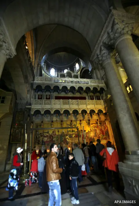 Palestinian and foreign worshippers walk outside the church of the Holy Sepulchre in Jerusalem's old city on December 30, 2012. The church has been a paramount - and for many Christians the most important - pilgrimage de...