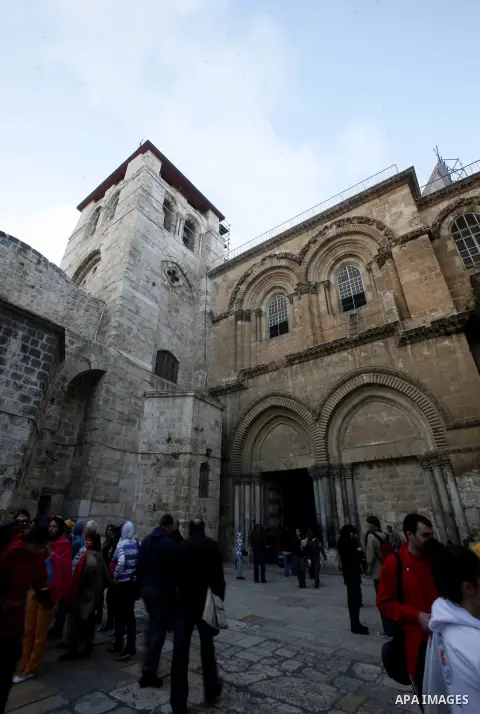Palestinian and foreign worshippers walk outside the church of the Holy Sepulchre in Jerusalem's old city on December 30, 2012. The church has been a paramount - and for many Christians the most important - pilgrimage de...