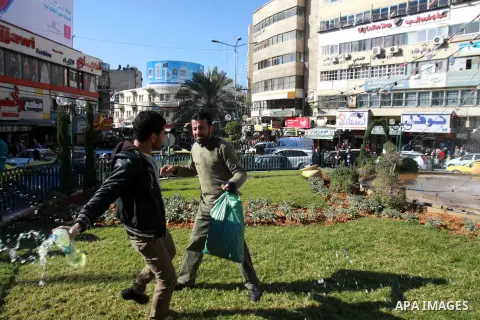 A Palestinian man stops Jomaa Abu Olifa, 47 years as he pours gasoline trying to set himself on fire during a demonstration against the economic situation and against Palestinian Prime Minister Salam Fayyad in the northe...