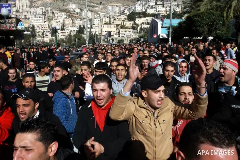 Palestinians shout slogans during a demonstration against the economic situation and against Palestinian prime minister Salam Fayyad in the northern West Bank city of Nablus on December 31, 2012. The protest came after F...