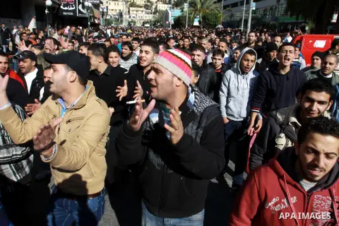 Palestinians shout slogans during a demonstration against the economic situation and against Palestinian prime minister Salam Fayyad in the northern West Bank city of Nablus on December 31, 2012. The protest came after F...