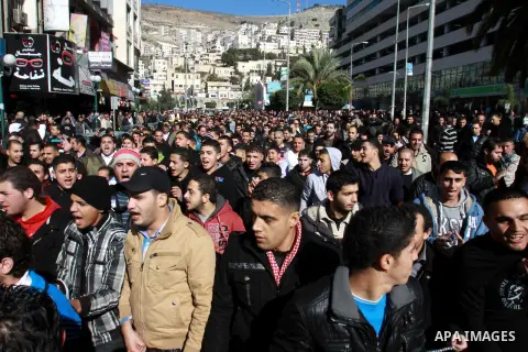 Palestinians shout slogans during a demonstration against the economic situation and against Palestinian prime minister Salam Fayyad in the northern West Bank city of Nablus on December 31, 2012. The protest came after F...
