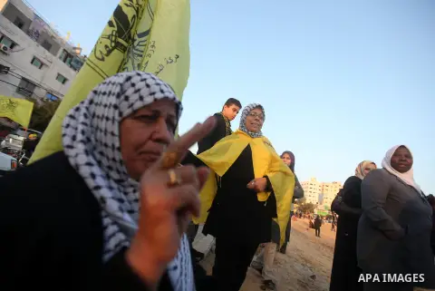 A Palestinian woman marks victory sign during a rally in Gaza city on December 31, 2012. The Gaza branch of Palestinian president Mahmud Abbas's Fatah party said on Friday it will mark its anniversary in the Hamas-ruled...