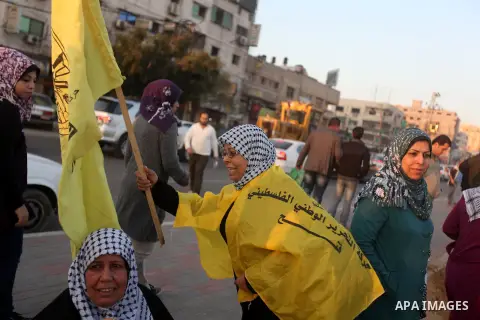 Palestinian supporters of Fatah movement hold the party's flags during a rally in Gaza city on December 31, 2012. The Gaza branch of Palestinian president Mahmud Abbas's Fatah party said on Friday it will mark its annive...