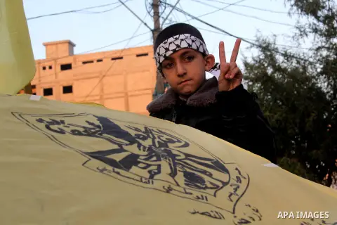 A Palestinian child marks victory sign during a rally in Gaza city on December 31, 2012. The Gaza branch of Palestinian president Mahmud Abbas's Fatah party said on Friday it will mark its anniversary in the Hamas-ruled...